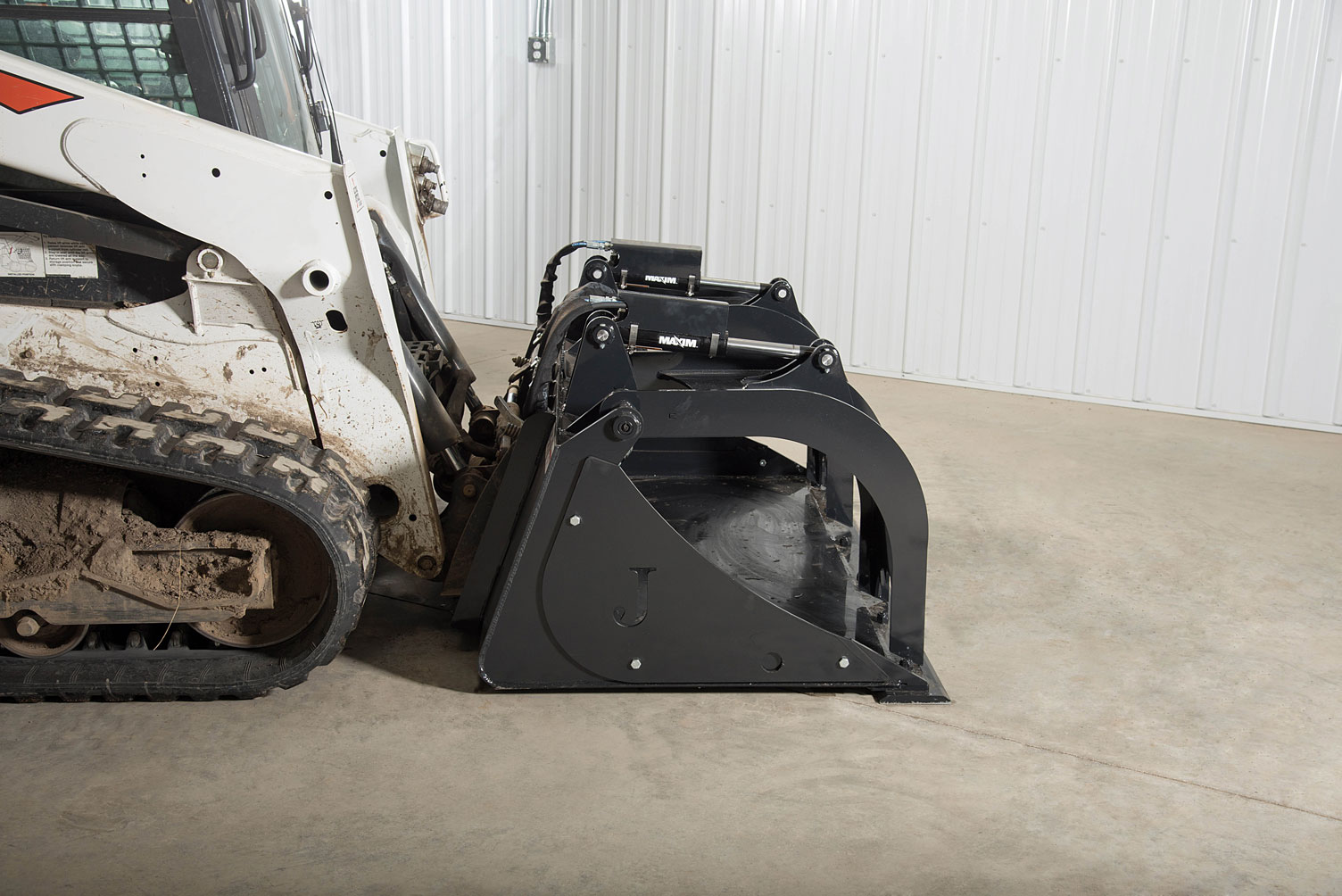 bobcat skid steer with a low profile grapple bucket