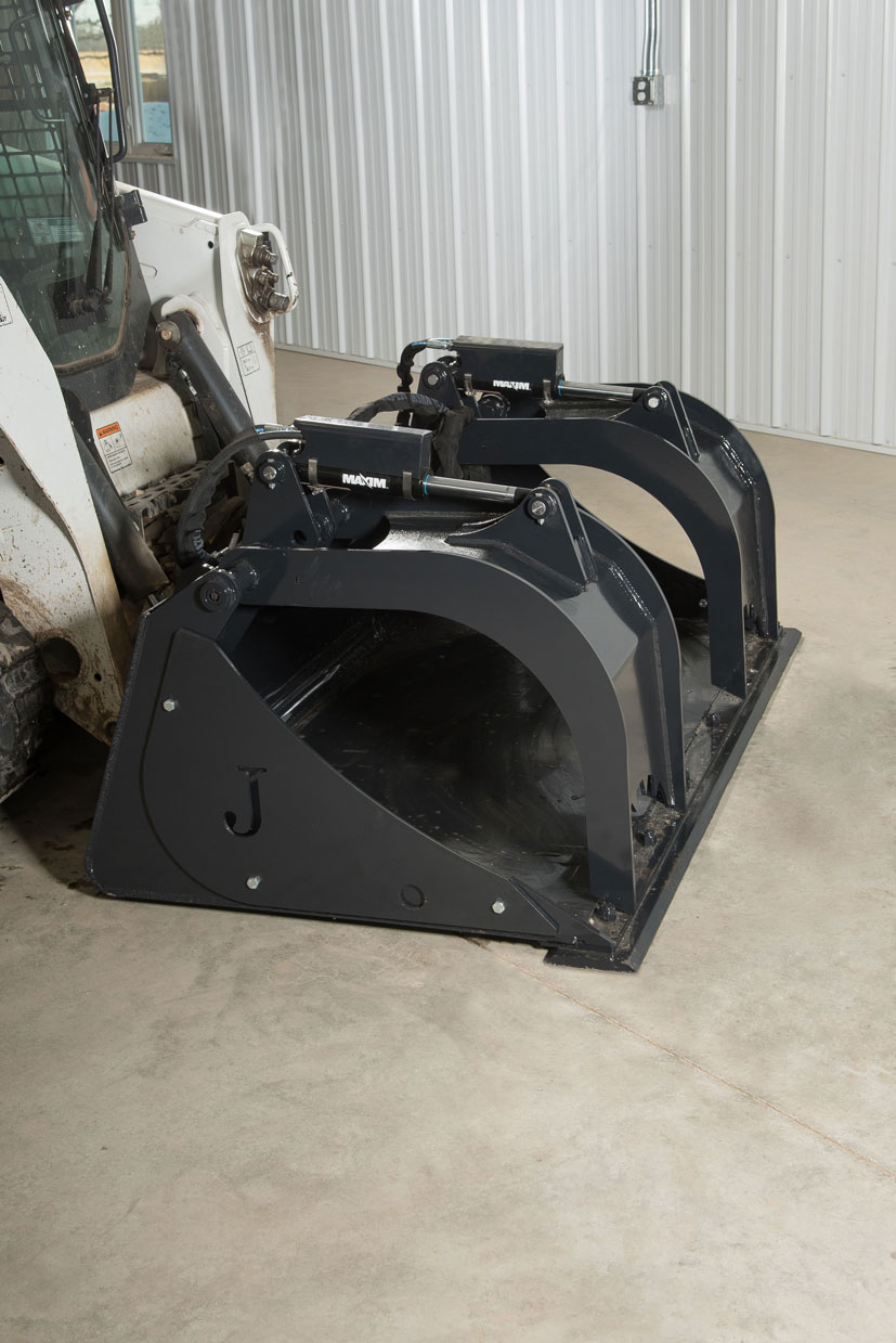 front angle image of a bobcat skid steer with a low profile grapple bucket